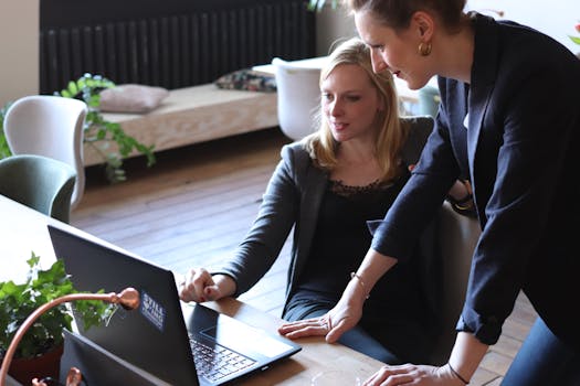 Women collaborating in a tech meeting