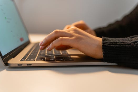 person coding on a laptop