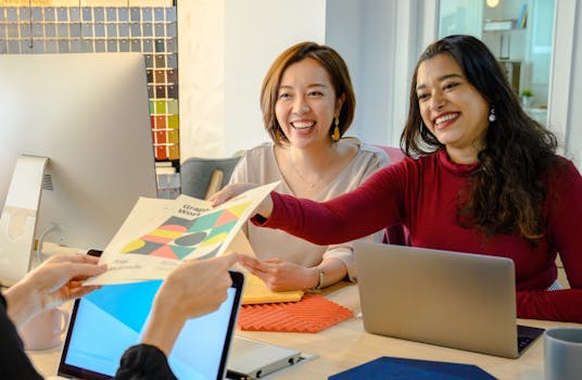 women collaborating over laptops